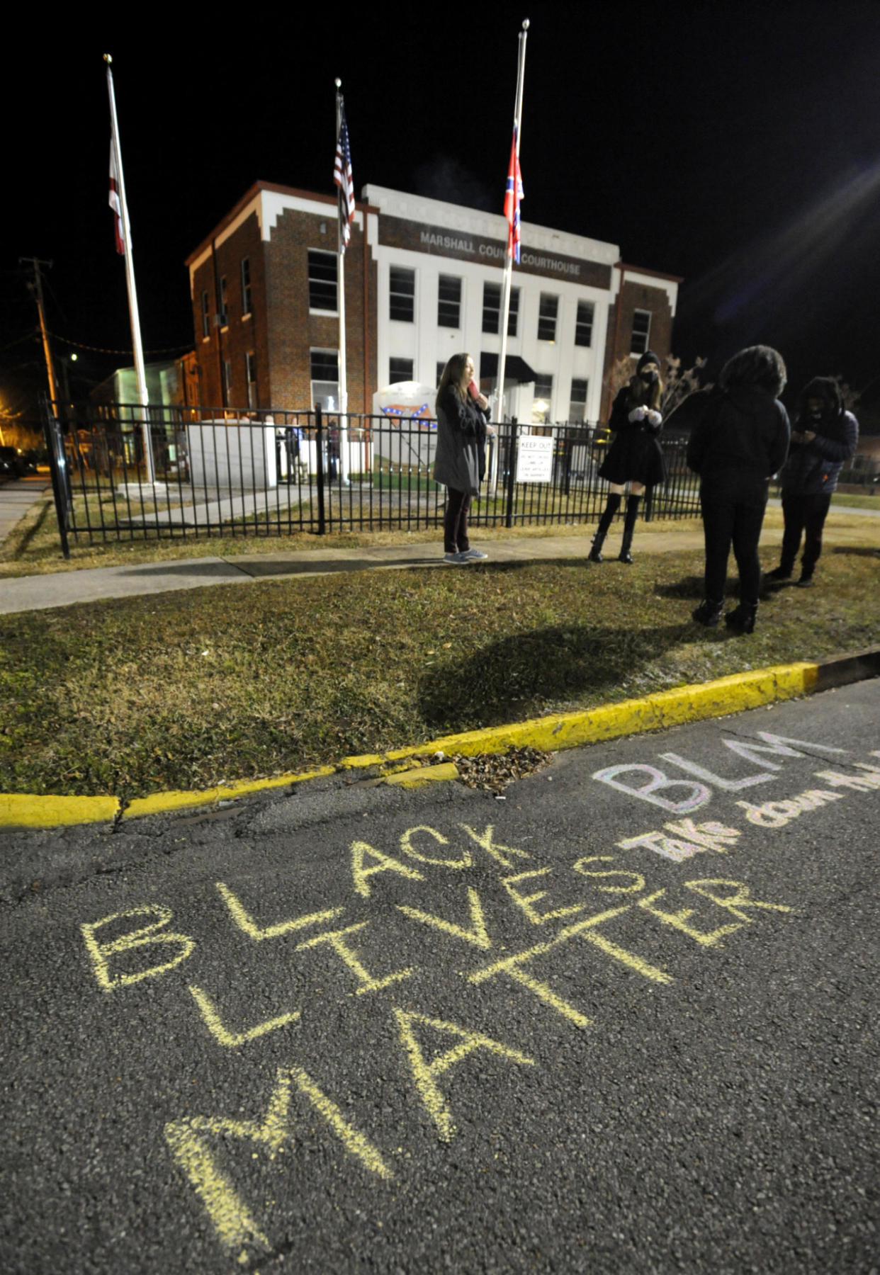 Demonstrators gather outside the Marshall County Courthouse in Albertville, Ala., on Wednesday, Dec. 9, 2020, following a protest against a Confederate monument and flag located on the lawn. Unique Morgan Dunston, a Black woman transformed by leaving the virtually all-white town where she grew up, has been leading the demonstrations since August. (AP Photo/Jay Reeves)