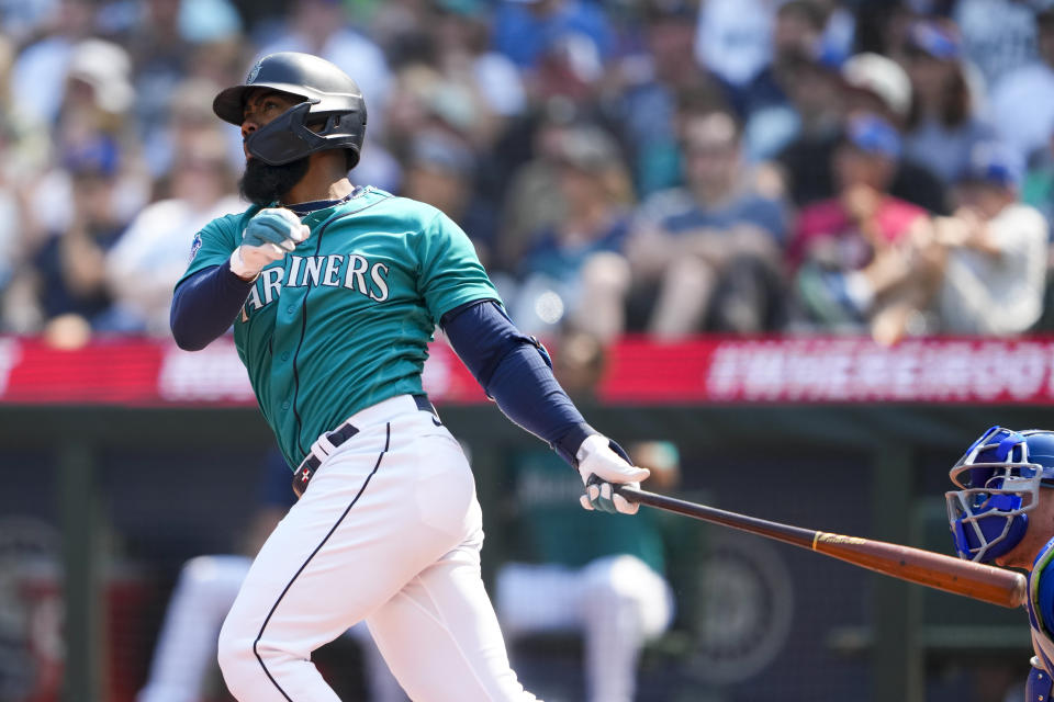 Seattle Mariners' Teoscar Hernandez follows through on a grand slam against the Kansas City Royals during the third inning of a baseball game Saturday, Aug. 26, 2023, in Seattle. (AP Photo/Lindsey Wasson)