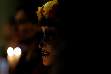 Activists with their faces painted to look like the popular Mexican figure "Catrina" take part in a march against femicide during the Day of the Dead in Mexico City, Mexico, November 1, 2017.REUTERS/Carlos Jasso