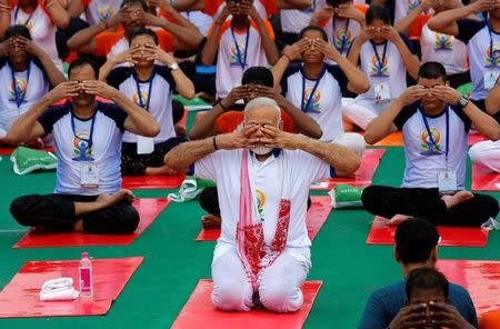 Prime Minister Narendra Modi performs yoga on International Yoga Day in Lucknow, June 21, 2017. REUTERS/Pawan Kumar