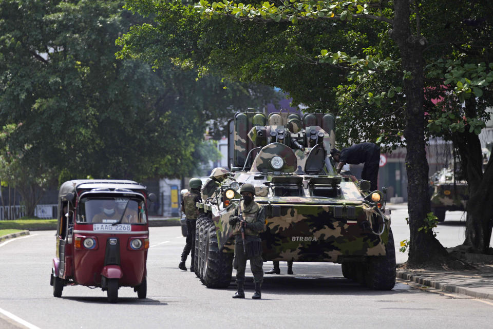 Sri Lankan army soldiers patrol during curfew in Colombo, Sri Lanka, Wednesday, May 11, 2022. Sri Lanka's defense ministry ordered security forces on Tuesday to shoot anyone causing injury to people or property to contain widespread arson and mob violence targeting government supporters.(AP Photo/Eranga Jayawardena)