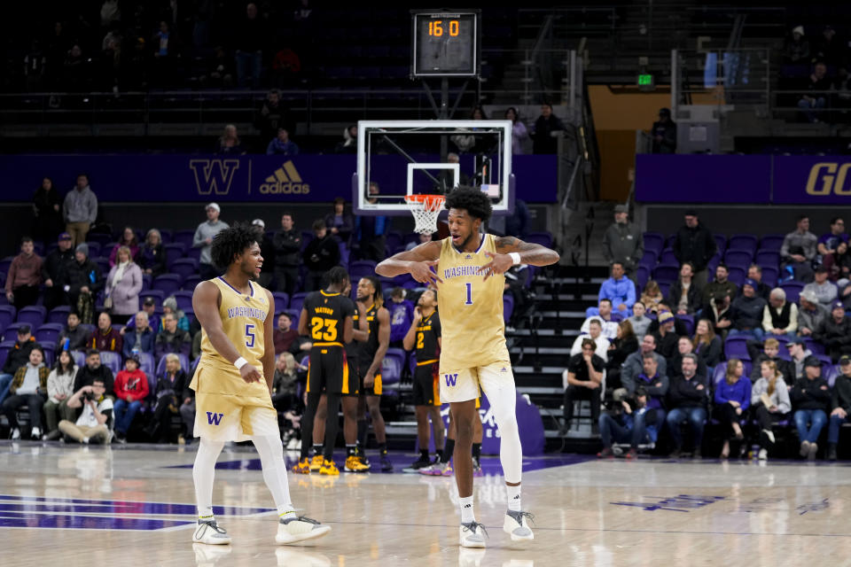 Washington guard Sahvir Wheeler (5) smiles next to forward Keion Brooks Jr. (1) during the second half of the team's NCAA college basketball game against Arizona State on Thursday, Jan. 11, 2024, in Seattle. (AP Photo/Lindsey Wasson)