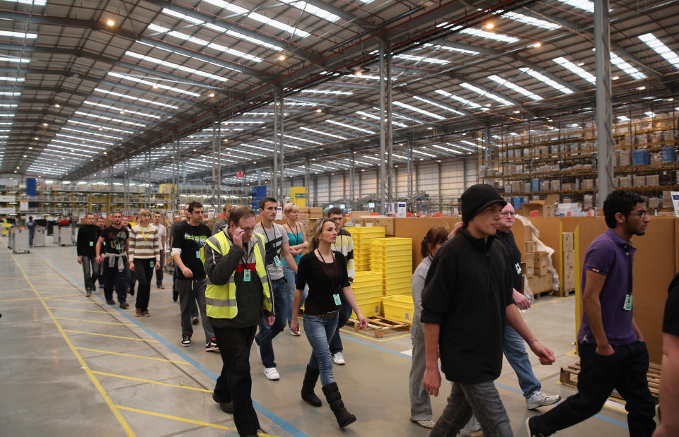 PETERBOROUGH, ENGLAND - NOVEMBER 28:  Employees select and dispatch items in the huge Amazon 'fulfilment centre' warehouse on November 28, 2013 in Peterborough, England. The online retailer is preparing for 'Cyber Monday', as it predicts the busiest day for online shopping in the UK will fall on Monday December 2nd this year. On Cyber Monday in 2012 amazon.co.uk recorded over 3.5 million individual items ordered, which equates to 41 items purchased per second. The Peterborough fulfilment centre is 500,000 sq ft, equivalent to approximately seven football pitches in floor area. Amazon are due to employ more than 1,000 seasonal staff to cope with increased demand in the run up to Christmas.  (Photo by Oli Scarff/Getty Images)