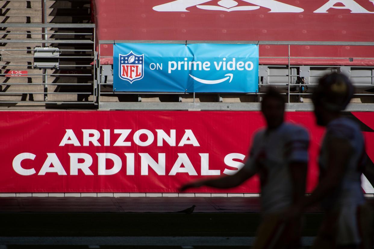 An "NFL on Prime Video" banner hangs on the field prior to a game on Dec. 26 between the San Francisco 49ers and Arizona Cardinals in Glendale, Ariz. The NFL will nearly double its media revenue to more than $10 billion a season with new rights agreements announced Thursday, including a deal with Amazon Prime Video that gives the streaming service exclusive rights to "Thursday Night Football" beginning in 2022.