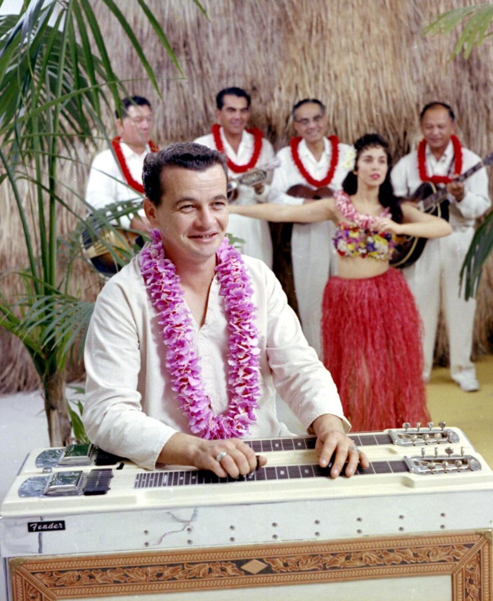 Speedy West sits at his pedal steel guitar.