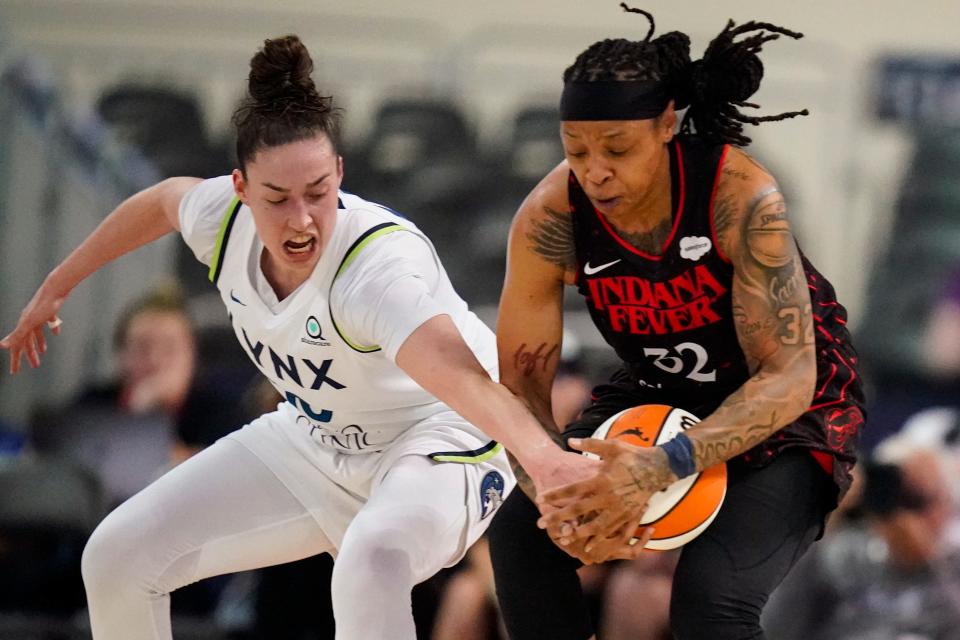 Minnesota Lynx forward Jessica Shepard (10) and Indiana Fever forward Emma Cannon (32) go for a loose ball in the first half of a WNBA basketball game in Indianapolis, Friday, July 15, 2022. (AP Photo/Michael Conroy)