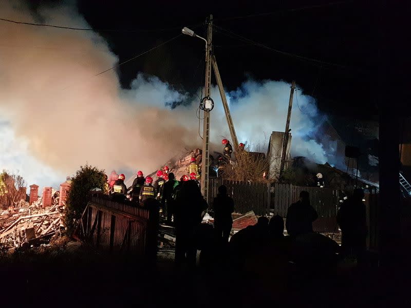 Firefighters work at the site of a building levelled by a gas explosion in Szczyrk