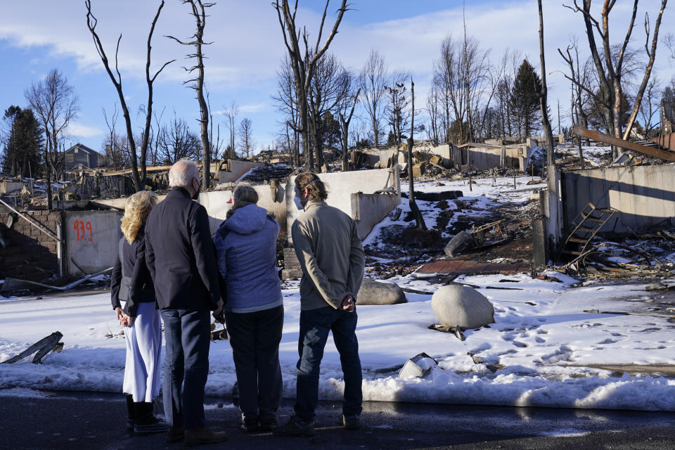 President Joe Biden and first lady Jill Biden talk with people as they tour a neighborhood in Louisville, Colo., Friday, Jan. 7, 2022, that was impacted by the recent wildfire. (AP Photo/Susan Walsh)