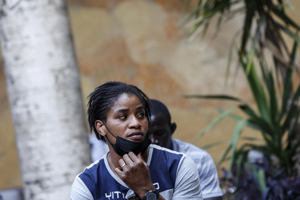 Freestyle wrestler Fatoumata Yarie Camara, of Guinea, waits to receive the COVID-19 vaccine at the Santo Spirito hospital in Rome, Saturday, July 3, 2021. A West African wrestler's dream of competing in the Olympics has come down to a plane ticket. Fatoumata Yarie Camara is the only Guinean athlete to qualify for these Games. She was ready for Tokyo, but confusion over travel reigned for weeks. The 25-year-old and her family can't afford it. Guinean officials promised a ticket, but at the last minute announced a withdrawal from the Olympics over COVID-19 concerns. Under international pressure, Guinea reversed its decision. (AP Photo/Riccardo De Luca)