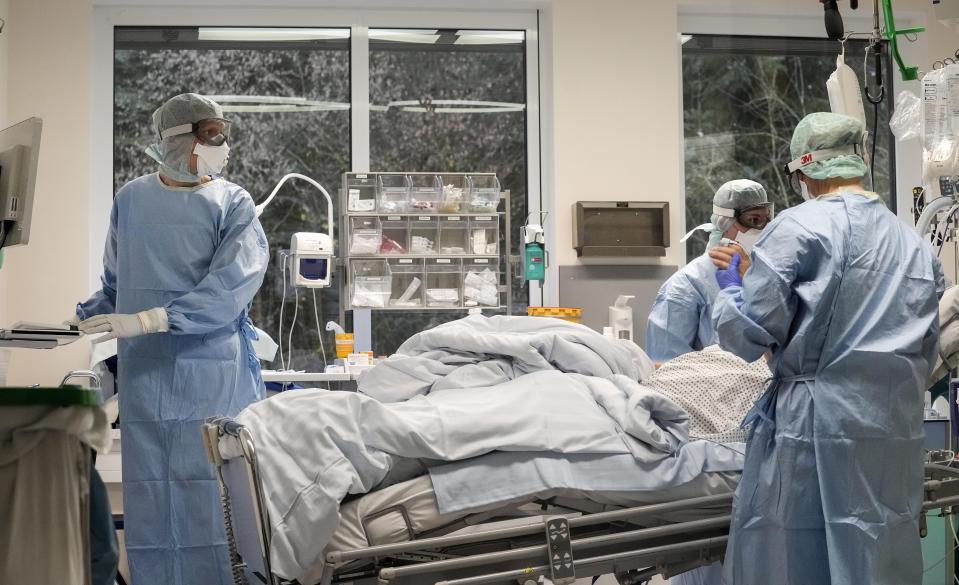 An intubated COVID-19 patient gets treatment at the intensive care unit at the Westerstede Clinical Center, a military-civilian hospital in Westerstede, northwest Germany, Friday, Dec. 17, 2021. (AP Photo/Martin Meissner)