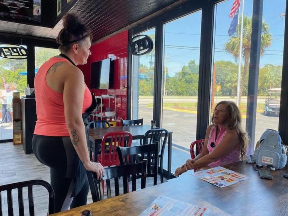 Tierney Boone talks with Tracy Bennett, who owns the new restaurant Dirty Myrtle Wing Co. with her husband, Troy. Sept. 4, 2023