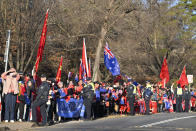 Supporters of Chinese Premier Li Qiang wait for his motorcade to pass outside Government House in Canberra, Monday, June 17, 2024. Li says he has agreed with Australian Prime Minister Anthony Albanese to properly manage their nations' differences as they emerge from a hostile era in which minister-to-minister contacts were banned and trade barriers cost Australian exporters up to $13 billion a year. (Mick Tsikas/Pool Photo via AP)