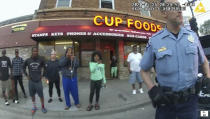 In this image from police body camera video former Minneapolis police Officer Derek Chauvin stands outside Cup Foods in Minneapolis, on May 25, 2020, with a crowd of onlookers behind him. The image was shown as prosecutor Steve Schleicher gave closing arguments as Hennepin County Judge Peter Cahill presided Monday, April 19, 2021, at the Hennepin County Courthouse in Minneapolis, in the trial of Chauvin who is charged in the May 25 death of George Floyd. (Court TV via AP, Pool)