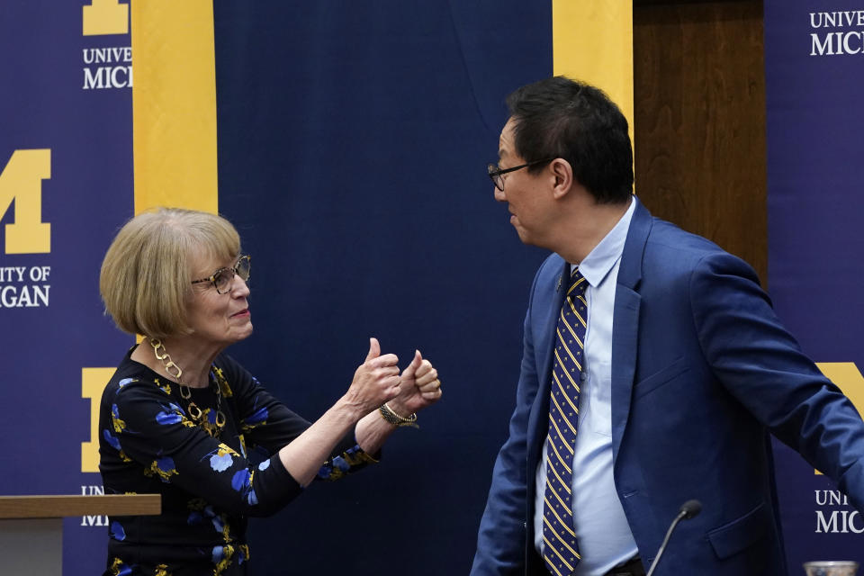 Mary Sue Coleman, the interim president of the University of Michigan, gives a thumbs up to Santa Ono after he is introduced as the new president of the University of Michigan, Wednesday, July 13, 2022, in Ann Arbor, Mich. Ono becomes UM's 15th president and its first minority and Asian chief executive — the son of Japanese immigrants who came to the United States after World War II. The 59-year-old Ono has led the University of British Columbia for nearly six years after guiding the University of Cincinnati for four years. (AP Photo/Carlos Osorio)