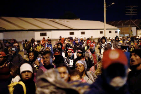 Central American migrants, moving in a caravan through Mexico, wait next to a railway before embarking on a new leg of their travels, in Tlaquepaque, in Jalisco state, Mexico April 19, 2018. REUTERS/Edgard Garrido