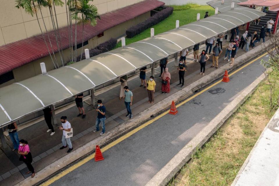 People queue outside the World Trade Centre Kuala Lumpur as they wait to receive the AstraZeneca Covid jab May 16, 2021. ― Picture by Firdaus Latif