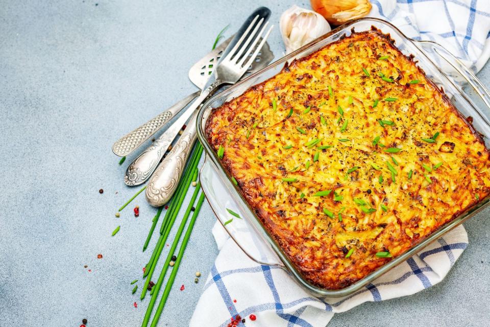 golden brown potato kugel in a clear baking dish