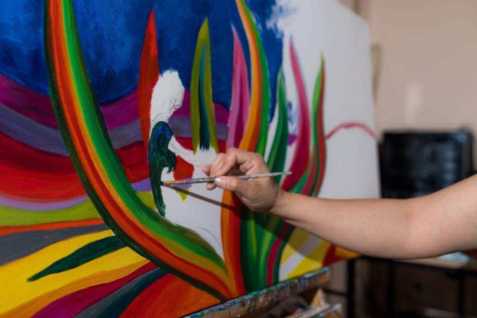 El Paso artist Blanca Estrada works on a commissioned painting in her home studio in El Paso on Thursday, March 22, 2023.