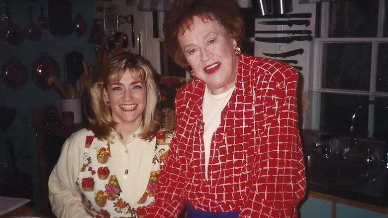 Gale Gand poses in kitchen with Julia Child