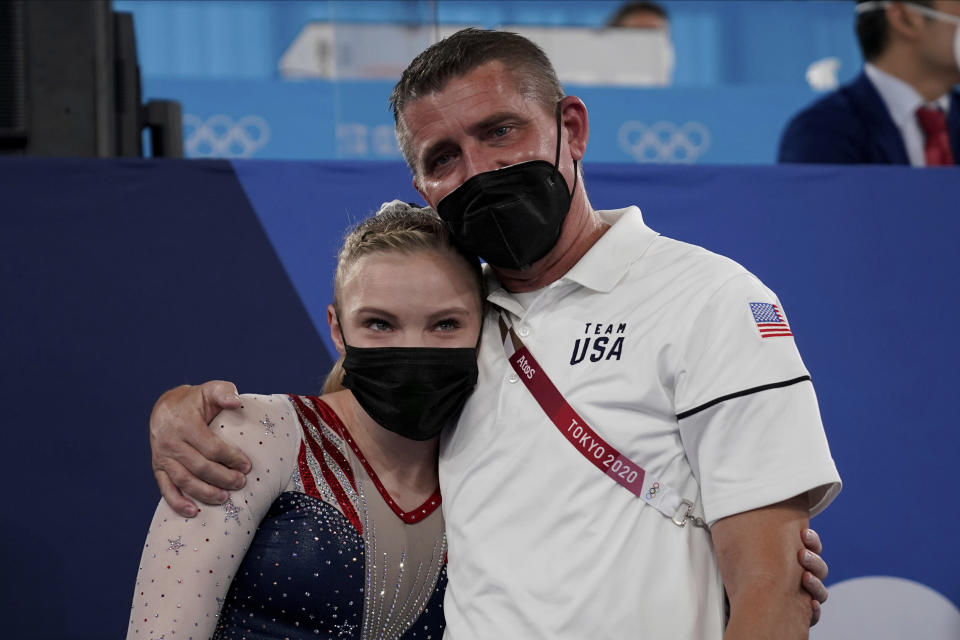 Jade Carey, of the United States, embraces her coach after winning the gold medal on the floor exercise during the artistic gymnastics women's apparatus final at the 2020 Summer Olympics, Monday, Aug. 2, 2021, in Tokyo, Japan. (AP Photo/Ashley Landis)