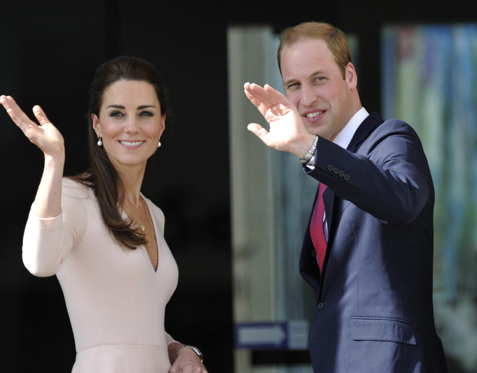 Britain's Prince William, right, and his wife Kate, left, the Duchess of Cambridge, wave to the crowd. Wednesday, April 23, 2014, in Adelaide, Australia. (AP Photo/David Mariuz)