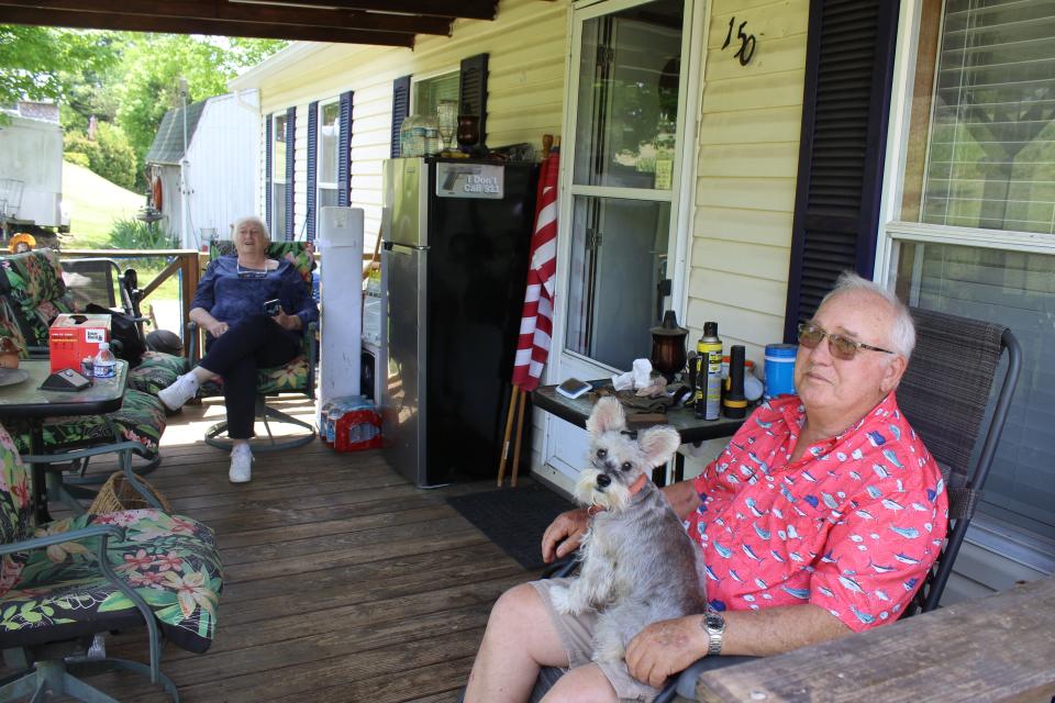 Fletcher and Brenda Letner, who are both fully vaccinated against covid-19, relax on their porch with their pooch, Hazzy, in Decatur, Tennessee. Like many Meigs County residents, the Letners said the high vaccination rate defied belief in an area where so many openly distrust the vaccines.