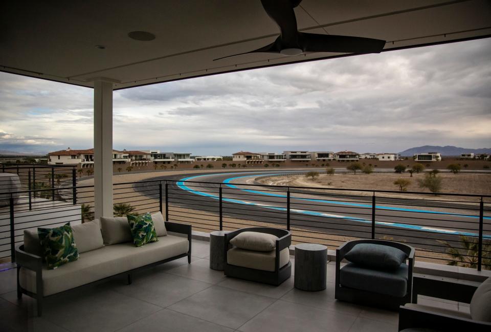 A lounge seating area is seen on the balcony of a member's home with a sweeping corner of the main track in the background at The Thermal Club in Thermal, Calif., Monday, Jan. 30, 2023. 