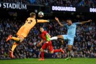 <p>Raheem Sterling and Simon Mignolet challenge for the ball </p>