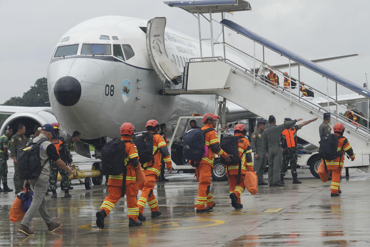 Members of Indonesian National Rescue Agency (BASARNAS) board an Air Force passenger jet before their departure to provide assistance to earthquake-hit areas in Turkey and Syria, at Halim Perdanakusuma air base in Jakarta, Indonesia, Saturday, Feb. 11, 2023. (AP Photo/Tatan Syuflana)