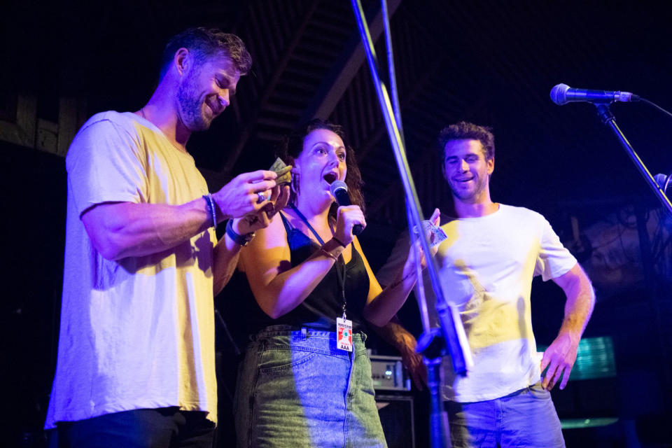 Celeste Barber looks happy on stage with Liam Hemsworth and Chris Hemsworth