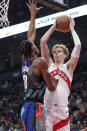 Toronto Raptors guard Gradey Dick (1) drives to the net as Brooklyn Nets center Nic Claxton (33) defends during the first half of an NBA basketball game in Toronto, Monday, March 25, 2024. (Nathan Denette/The Canadian Press via AP)