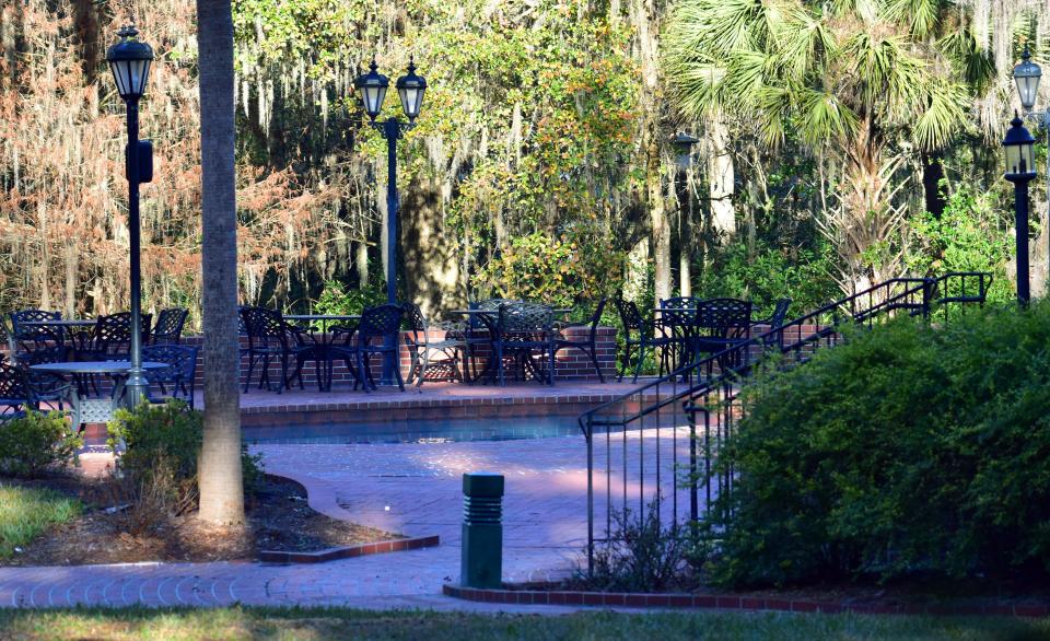 The pool of the Earl and Christy Powell University House, which housed University of Florida presidents until 2006, is positioned behind the house with tables and chairs surrounding it on Wednesday, Jan. 11, 2022.