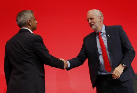Britain's Labour Party leader Jeremy Corbyn (R) shakes hands with Mayor of London Sadiq Khan after his speech during the third day of the Labour Party conference in Liverpool, Britain, September 27, 2016. REUTERS/Darren Staples