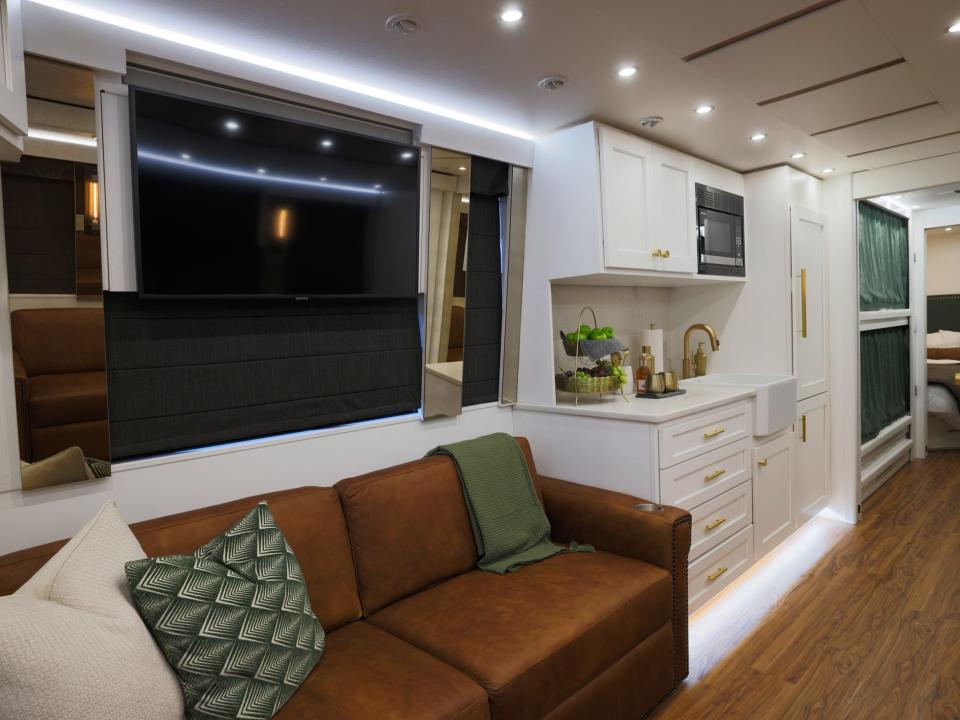 inside a luxury bus with couch, kitchen