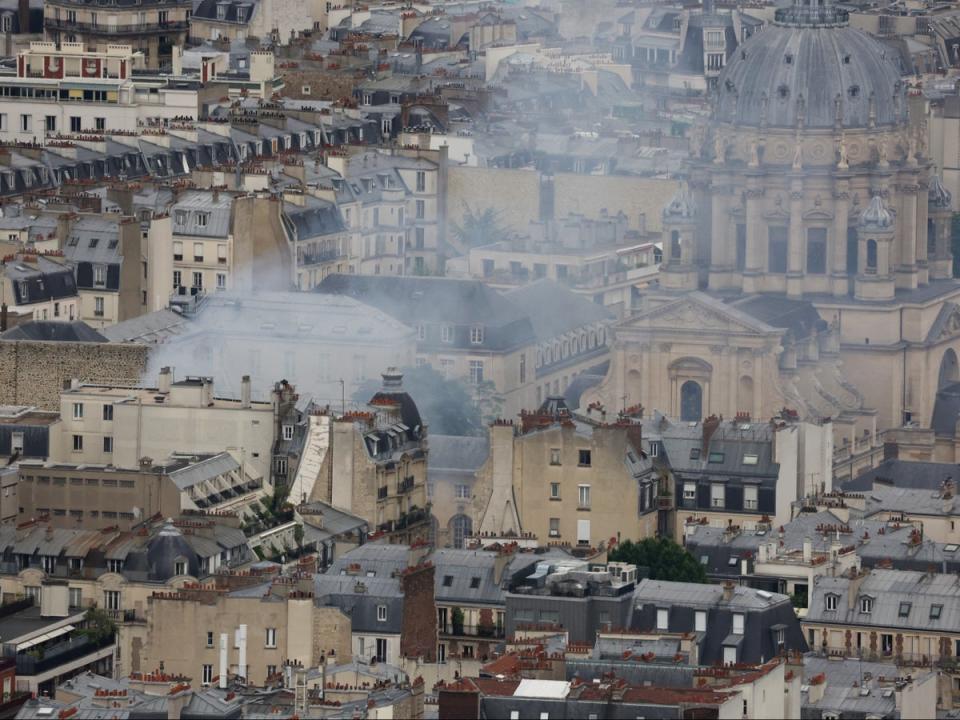 Smoke from the building billows over Paris (Reuters)