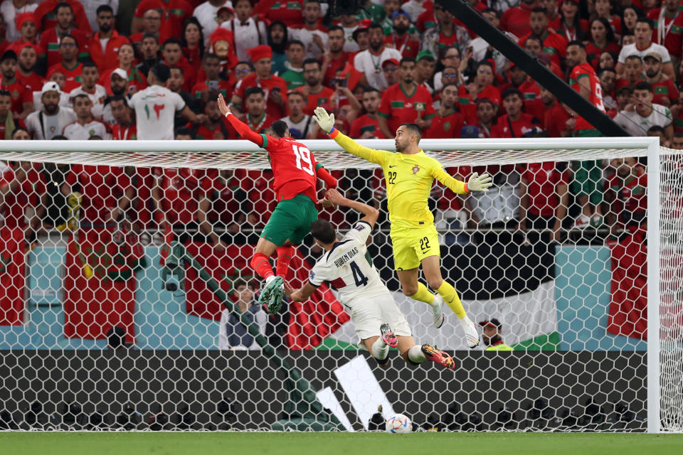 DOHA, QATAR - DECEMBER 10: Youssef En-Nesyri of Morocco heads to score the team's first goal during the FIFA World Cup Qatar 2022 quarter final match between Morocco and Portugal at Al Thumama Stadium on December 10, 2022 in Doha, Qatar. (Photo by Michael Steele/Getty Images)