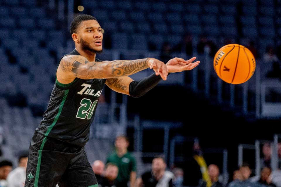 Tulane guard Devon Baker (20) passes the ball in the first half of an NCAA college basketball game against Houston in the semifinals of the American Athletic Conference tournament in Fort Worth, Texas, Saturday, March 12, 2022. (AP Photo/Gareth Patterson)