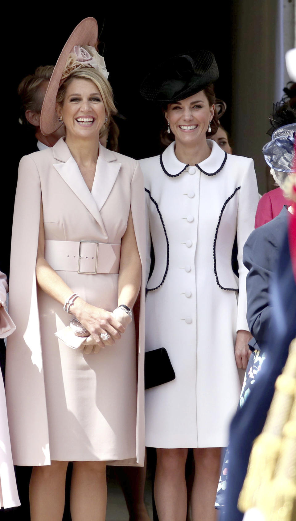 Queen Maxima of the Netherlands and Britain's Kate, Duchess of Cambridge stand together as they watch the annual Order of the Garter Service at St George's Chapel, Windsor Castle in Windsor, England, Monday, June 17, 2019. (Steve Parsons/Pool Photo via AP)