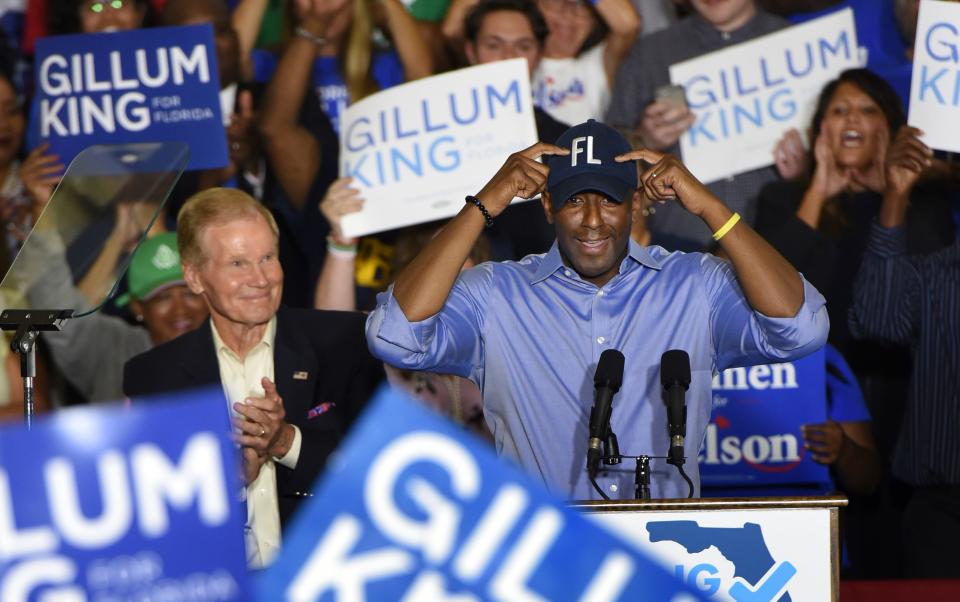 Florida Gubernatorial Democratic candidate Andrew Gillum puts on his Florida ball cap during a rally Monday, Oct. 22, 2018.