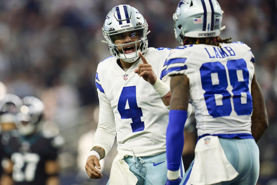 Dallas Cowboys quarterback Dak Prescott (4) celebrates after a touchdown pass to CeeDee Lamb (88) against the Philadelphia Eagles on December 24, 2022 in Arlington, Texas. (Photo by Cooper Neill/Getty Images)