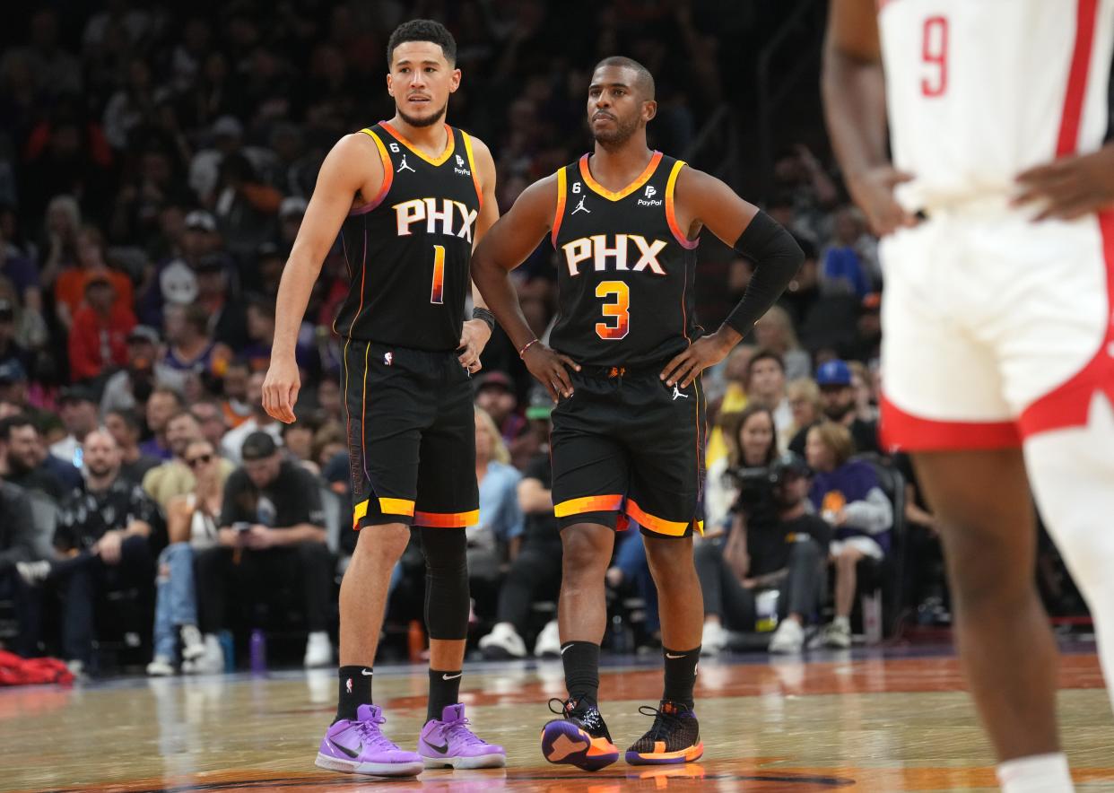 Oct 30, 2022; Phoenix, AZ, USA; Phoenix Suns guards Chris Paul (3) and Devin Booker (1) share the backcourt against the Houston Rockets at Footprint Center.