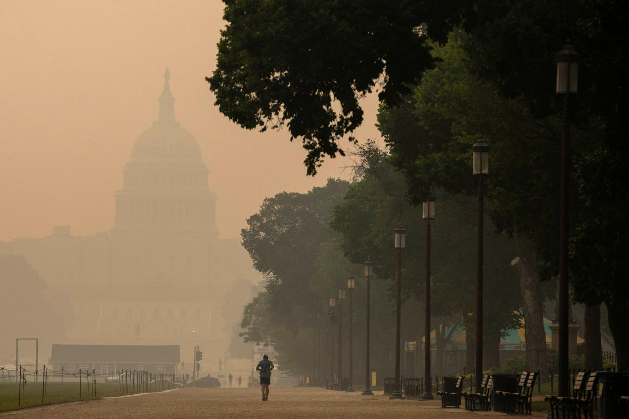 A person runs on the National Mall as the U.S. Capitol is seen shrouded in haze and smoke caused by wildfires in Canada, in Washington, U.S., June 8, 2023. (Amanda Andrade-Rhoades/Reuters)