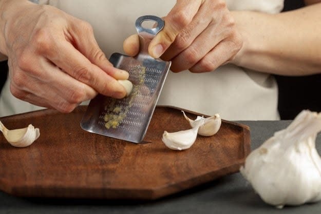 Grating garlic on a small grater