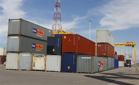 A truck is loaded with a container at the Port of Montreal, September 27, 2010. REUTERS/Shaun Best