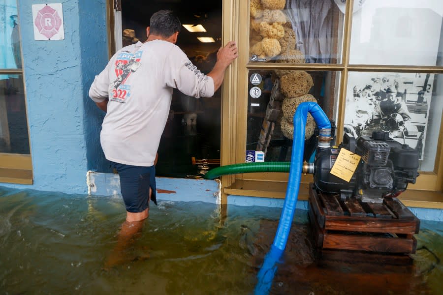 Sponge Diver Supply owner works to deal with the storm surge from Hurricane Idalia in Tarpon Springs, Fla., on Wednesday, Aug. 30, 2023. (Ivy Ceballo/Tampa Bay Times via AP)