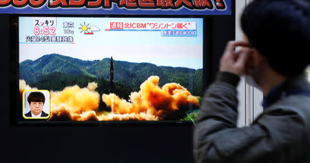 A man looks at a street monitor showing a news report about North Korea's missile launch, in Tokyo, Japan, November 29, 2017. REUTERS/Toru Hanai