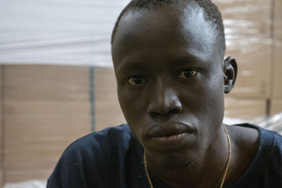 Alei Wuch Alei, a 21-year-old from the Warrap province of South Sudan and rescued from the sea some 30 miles off Libya, sits onboard the humanitarian ship Geo Barents, Friday, Oct. 6, 2023. “I crossed the desert from Sudan to Libya and I tried three times to cross the sea,” he said, retelling his journey. Badly advised by relatives and friends, misled by insufficient official information or poor translation services, many can end up in legal limbo for years, cut off from any government aid. (AP Photo/Paolo Santalucia)