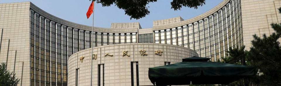 FILE PHOTO: Paramilitary police officers stand guard in front of the headquarters of the People