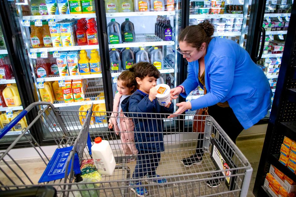 Mollie Reid shops for groceries with her children Oliver and Skye in Oklahoma City.