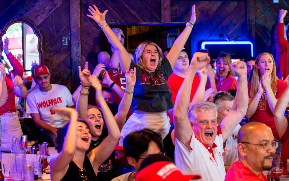 NC state fans at Players’ Retreat in Raleigh celebrate a Wolfpack lead against Duke during the second half of the Elite Eight round of the NCAA Men’s Division I Basketball Tournament on Sunday, March 31, 2024.
